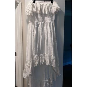 Smocked off shoulder white dress with high low hem.